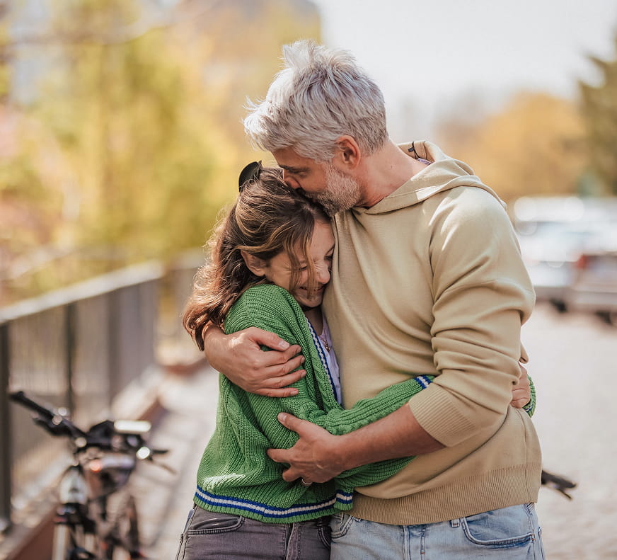 Chance to Thrive - A father holding and kissing his daughters head