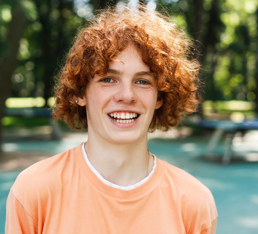 smiling teen in a park