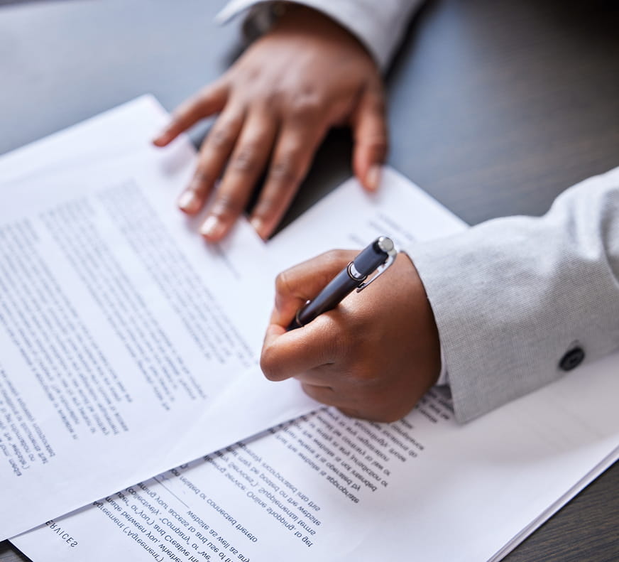 someone writing on paperwork